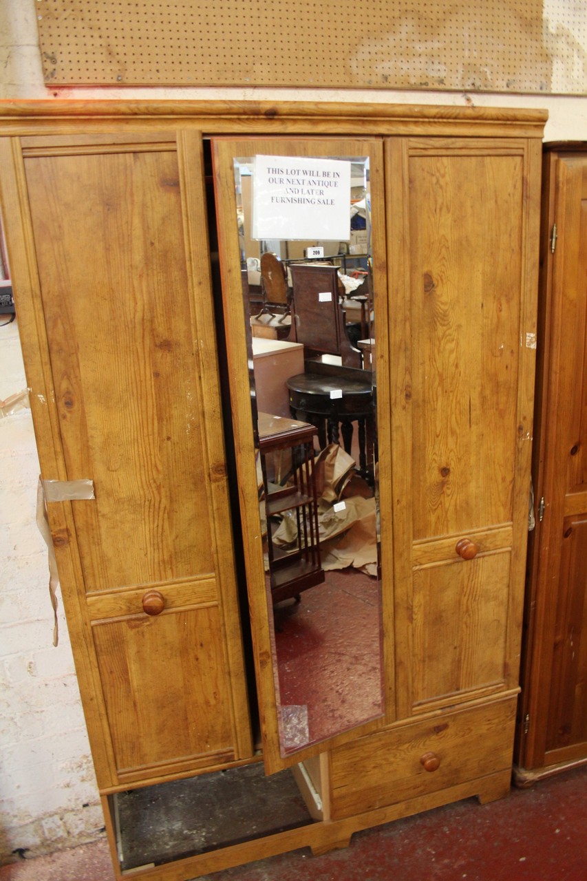 A modern pine wardrobe with central mirrored door.Best Bid