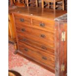 An Edwardian walnut chest of drawers with two short drawers over three long.