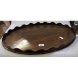 Edwardian mahogany oval tray with wavy border and satinwood banding, 57cm wide