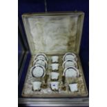 A 20th century cased set of six Limoges porcelain coffee cans and saucers, blue borders with gilt