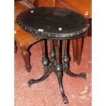 A Victorian Aesthetic ebonised oval lamp table 61cm wide