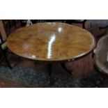 A Victorian burr walnut oval table on turned column and floral carved legs 135cm wide