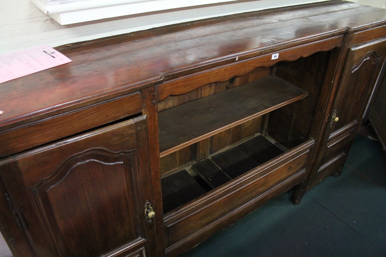 A French chestnut side cupboard, 19th century with an open shelf to the middle flanked by