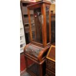 An early 20th century tall narrow display cabinet with a central glazed jewellery section.