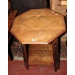 An oak octagonal Arts and Crafts style octagonal table with heart pierced supports joined by an
