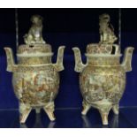 A pair of Japanese Satsuma two-handled vases with covers, Dog of Fo finials, ovoid shaped, with