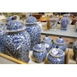 A pair of modern Chinese blue and white ceramic vases with covers, baluster shaped, foliate