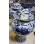 A pair of modern Chinese blue and white ceramic vases with covers, baluster shaped, decorated with