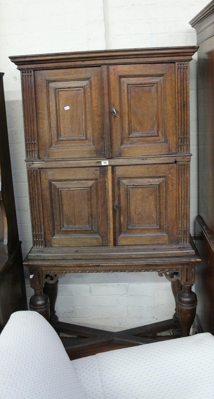 An oak 19th Century cabinet with panelled doors raised on bulbous turned supports.