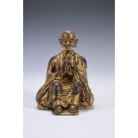 A Tibetan gilded figure of a monk, 18th century  A Tibetan gilded figure of a monk, 18th