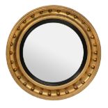 A Regency carved giltwood convex wall mirror, circa 1815  A Regency carved giltwood convex wall