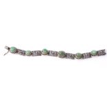 An emerald bracelet, the articulated bracelet composed of pierced and... An emerald bracelet, the