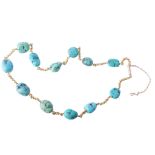 A turquoise necklace, the turquoise beads on a curb link chain A turquoise necklace, the turquoise