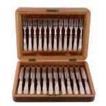 A late Victorian set of twelve electro-plated dessert knives and forks  A late Victorian set of