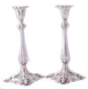 A pair of silver coloured candlesticks, unmarked  A pair of silver coloured candlesticks,