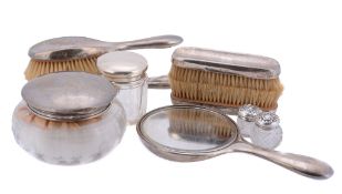 A collection of dressing table items, including four glass jars with silver...  A collection of