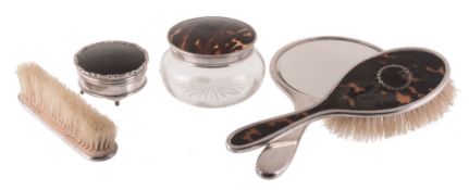 A matched silver and tortoiseshell dressing table set, differing makers  A matched silver and