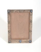 A silver and enamel rectangular photograph frame by Liberty & Co  A silver and enamel rectangular