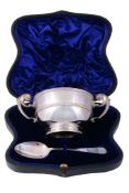 A late Victorian/Edwardian silver twin handled christening bowl and spoon by...  A late Victorian/
