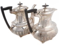 A matched pair of Edwardian silver oblong baluster cafe au lait pots by...  A matched pair of
