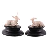 A pair of 19th century European carvings of a recumbent stag and doe  A pair of 19th century