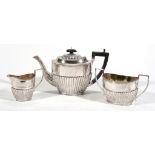 A silver oval half reeded three piece tea service by Joseph Gloster Ltd  A silver oval half reeded