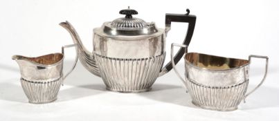 A silver oval half reeded three piece tea service by Joseph Gloster Ltd  A silver oval half reeded
