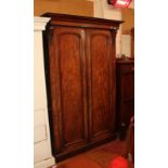 A Victorian mahogany wardrobe with two arched panelled doors.
