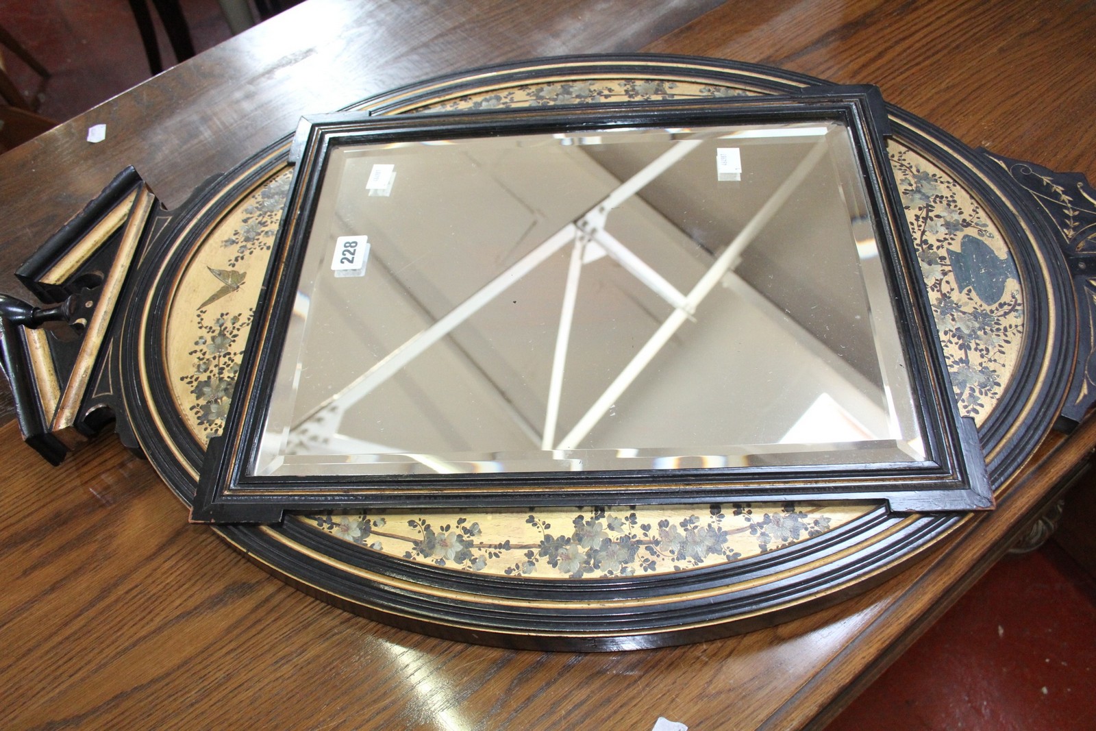 An Arts and Crafts Victorian oval looking glass with floral surround 93cm high, 49cm wide
