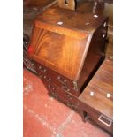 A reproduction mahogany bureau with four long drawers on bracket feet 53cm wide and a drop leaf