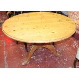 A pine circular dining table on carved column and tripod base 137cm diameter