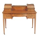 An Edwardian Carlton House desk, circa 1905, with inlaid decoration, the raised back with stationery