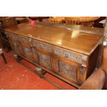 A carved oak sideboard with drawers and cupboards on carved bulbous legs joined by stretchers Best