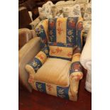 An early 20th Century upholstered armchair.