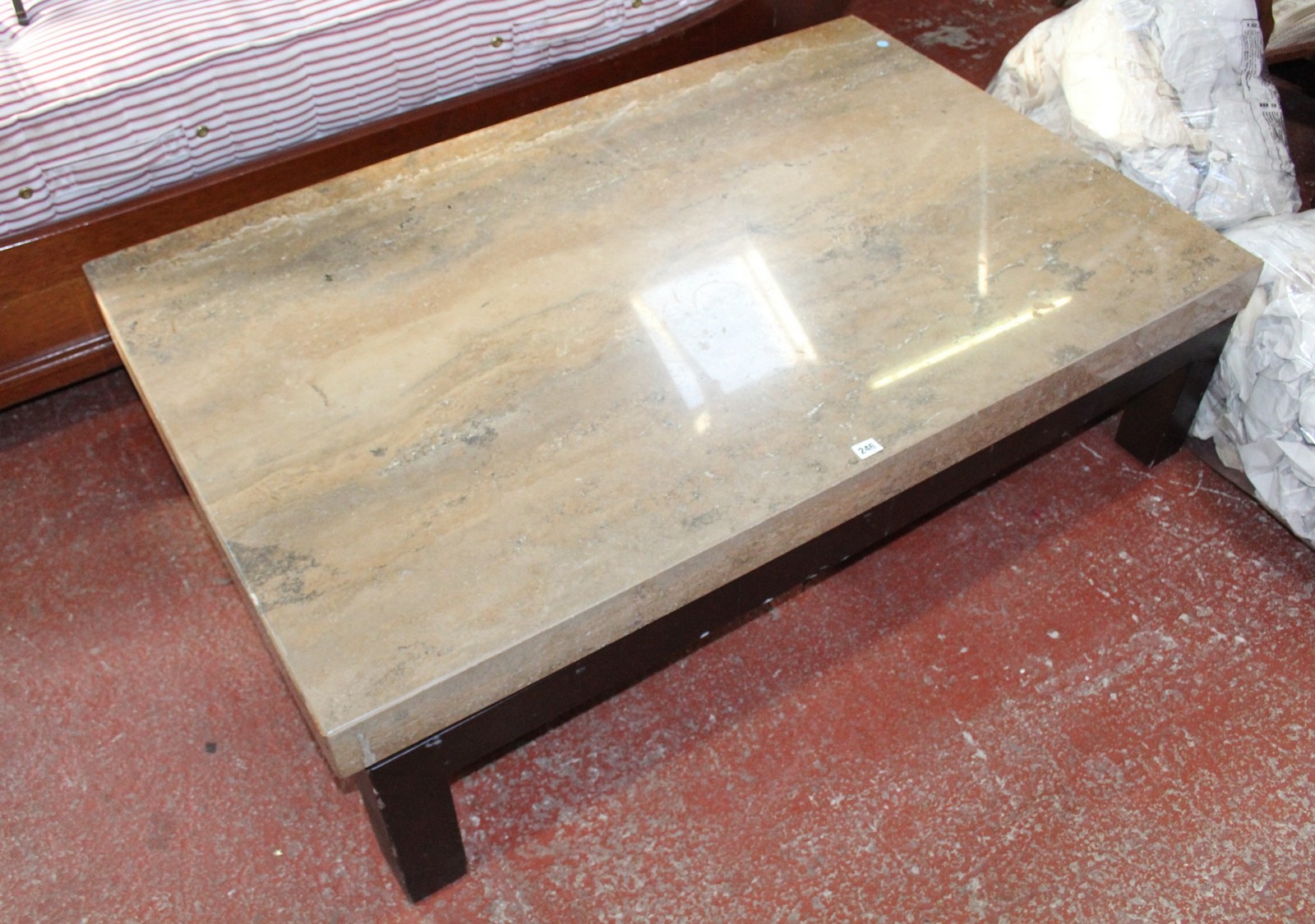 *An ebonised coffee table (marble/stone veneered top) 140cm length, 90cm depthBest Bid
