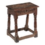 An oak joint stool, circa 1660 and later, the rectangular seat above a lunette carved frieze,