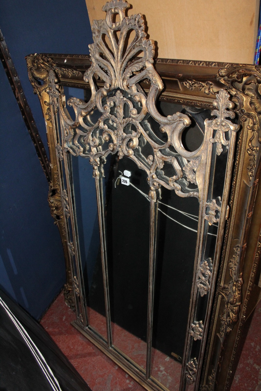 An 18th century style gold composition overmantel with three central divisions. 152cm x 73cm.