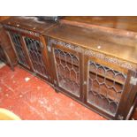 A pair of oak Jacobean style glazed bookcasesBest Bid