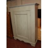 A large painted cupboard, the moulded panel door enclosing shelves 190cm high, 144cm wide.