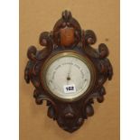 A mahogany aneroid wheel barometer, an oak aneroid barometer and an oak wall mounted telephone (3)