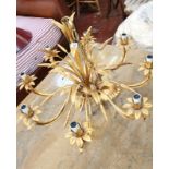 A gilt metal eight branch chandelier with sprays of sheaves and leaves