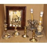 A pair of gilt metal table lamps, a pair of brass candlesticks, a walnut framed bevelled mirror