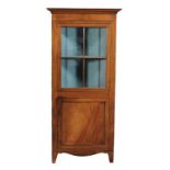 A Regency mahogany and inlaid corner cupboard, circa 1820, with a moulded cornice and glazed