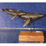 A 20th century Scott Nelles humpback whale and calf bronze sculpture, on wooden plinth base,