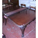 A Victorian mahogany extending dining table, on swept supports.
