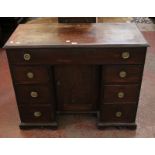 A 19th Century mahogany kneehole desk with one long drawer and six short drawers flanking central