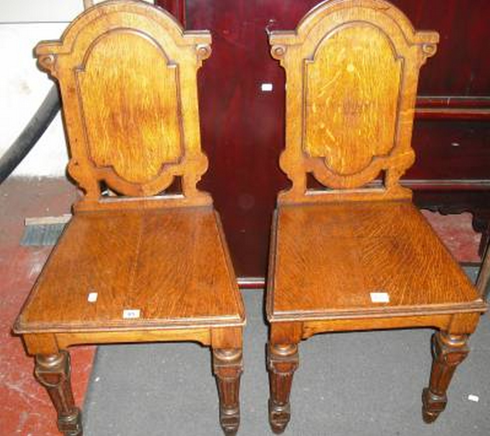 *A pair of Victorian oak hall chairs.