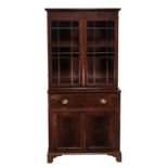 A George III mahogany secretaire bookcase, circa 1790, the moulded cornice above a pair of