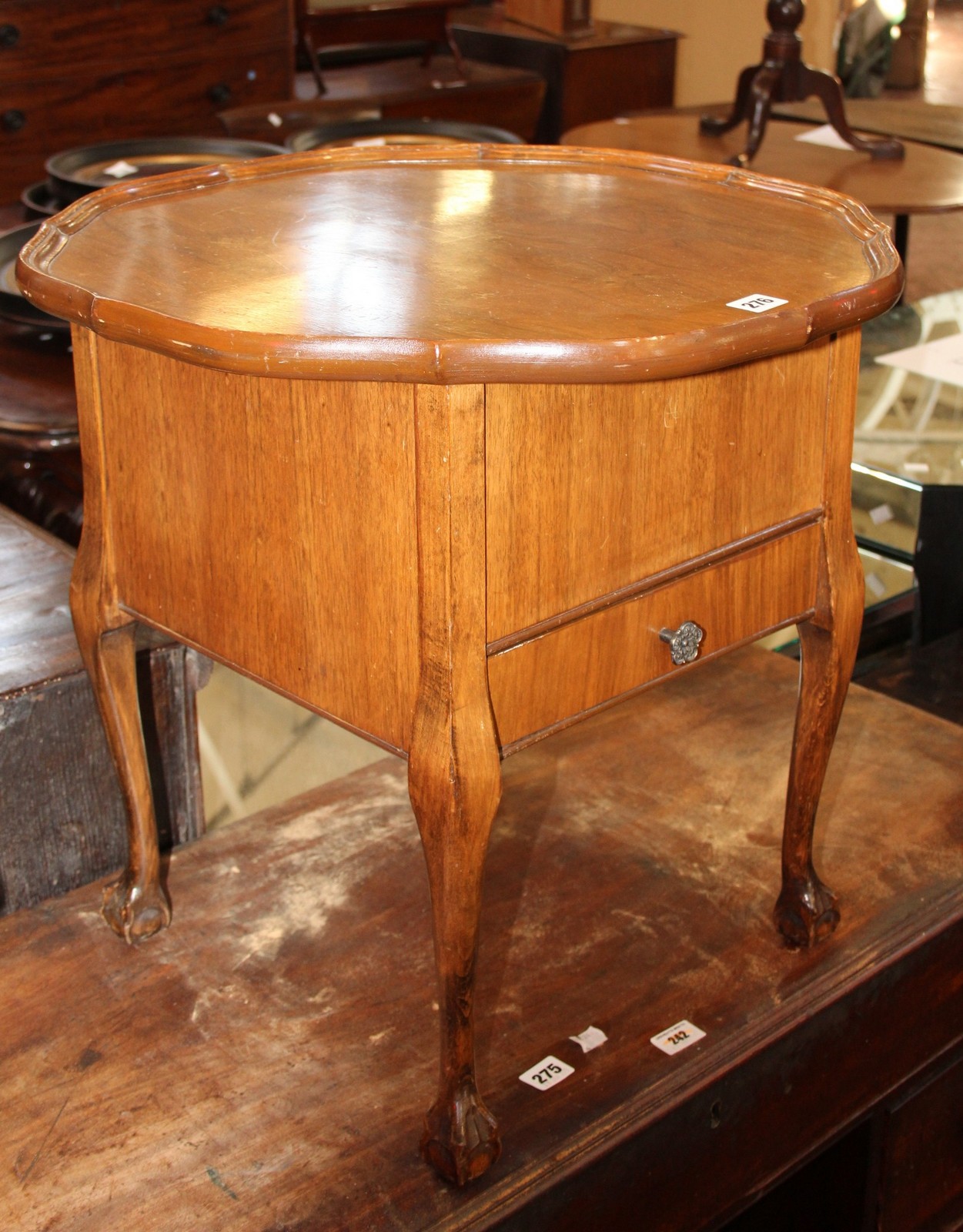 A 1930's walnut sewing table with a hinged top.
