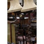 A pair of early 20th Century stained standard lamps in the Italianate style carved throughout with